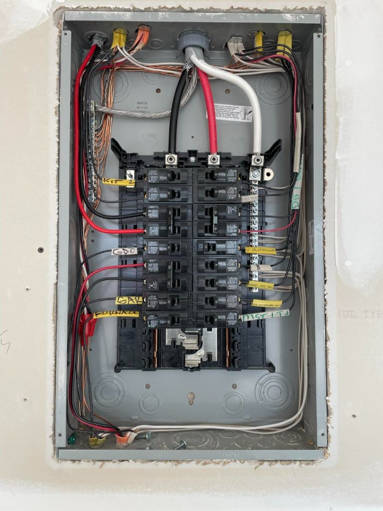 Open residential panel with neatly labeled kitchen and garage circuits