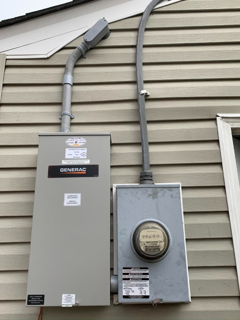 Generac transfer switch and electric meter on home exterior